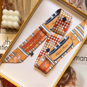 Slim silk-like scarf with orange geometric patterns in a luxury gift box