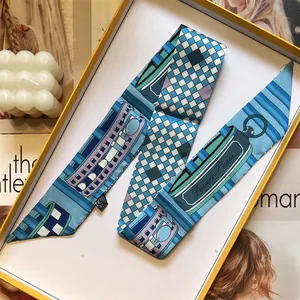 Blue silk-like twilly scarf with check print in a luxury orange gift box setup