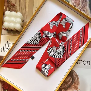 Double-sided silk twilly scarf with zebra print and polka dots in an orange gift box