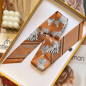 Double-sided silk satin twilly scarf with zebra print and polka dots in warm orange tones