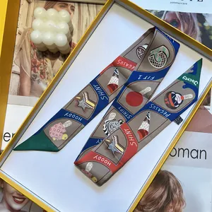 Detailed pattern of colorful silk twilly scarf with Pegasus text in a luxury gift box