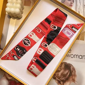 Close-up of bright red vintage print twilly silk scarf presented in an elegant gift box