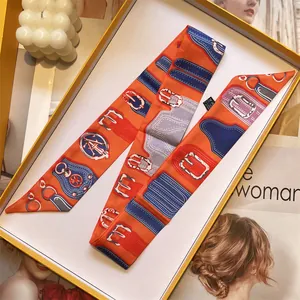 Detail of premium orange silk scarf with vintage geometric belt print in luxury gift box
