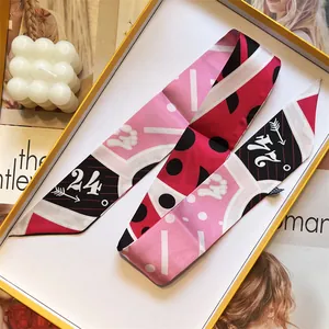 Silk twilly scarf with pink geometric pattern and number 24 in an elegant gift box