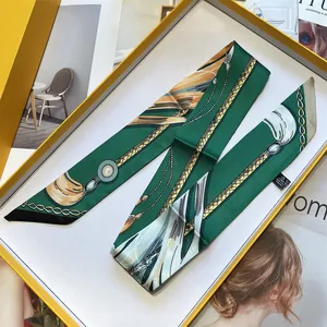 French style green twilly scarf with horsebit print in a luxury yellow gift box