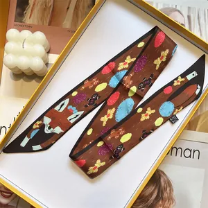 Detail of silk twilly scarf with cute fox and gingerbread man patterns in brown