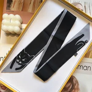 Cat print narrow silk scarf in black and grey, elegantly presented in a yellow gift box