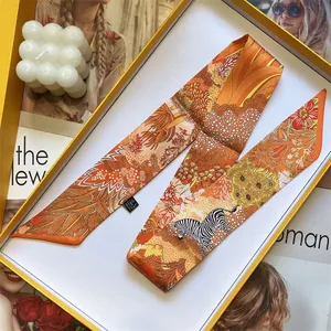 Detail of premium silk scarf with zebra floral print inside a yellow luxury gift box