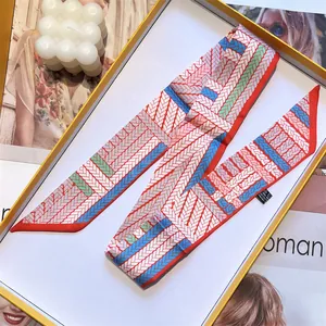 Elegant red and blue geometric twill silk scarf tied in a luxury gift box packaging