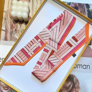 Pink and orange silk twilly scarf with woven pattern in a luxury yellow gift box