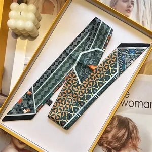 Elegant silk twilly scarf with vintage geometric patterns and floral motifs in a gift box