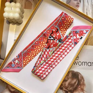 Close-up of a colorful patterned twilly silk scarf neatly folded inside a yellow gift box
