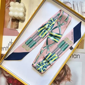 Elegant French equestrian style silk scarf with horse harness patterns in pink and navy blue