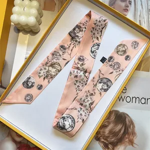 Detailed macro of 100% silk twilly scarf with vintage coin and floral prints in a gift box