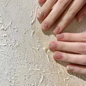 Handmade cat-eye press-on nails with cherry art and silver glitter on light pink base