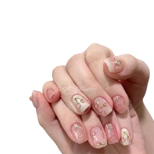 Handmade cat-eye press-on nails featuring glitter pink and cherry designs on model hands
