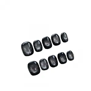 Handmade black cat eye press-on nails with silver shimmer and high-gloss finish