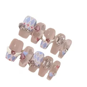Handmade 3D press-on nail set with angel wings, heart gems, and blue diamond patterns