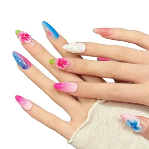 3D floral embossed almond press-on nails with pink-blue gradient and rhinestone details