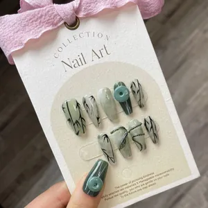 Handmade emerald green press-on nails with bamboo leaf painting and 3D jade snake design