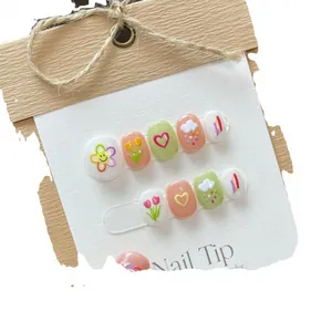 Handmade press-on nails with pastel macaron colors and cute hand-painted floral art