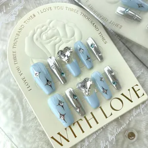 Handmade press-on nails with blue salt stars and heart rhinestones in coffin shape