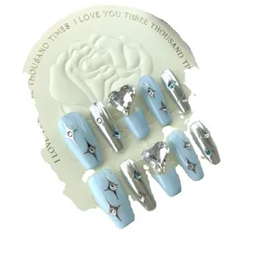 Handmade press-on nails in light blue and silver mirror finish with heart rhinestones