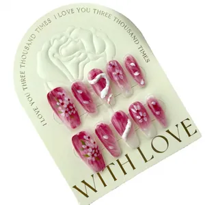 Pink press-on nails set with floral hand-painted designs and 3D white snake charms