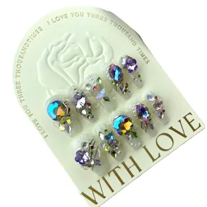 Luxury handmade press-on nails with purple sparkling crystals and floral rhinestones