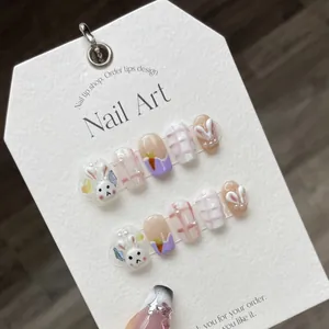 Handmade press-on nails featuring cute hand-painted bunny, carrot motifs and pink plaid
