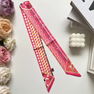 Detail of floral geometric twilly scarf showing polyester fabric texture and care label