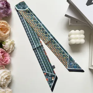 Detailed view of geometric pattern long silk scarf with decorative flowers and books