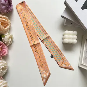 Detail shot of long silk scarf twilly with geometric patterns and care label