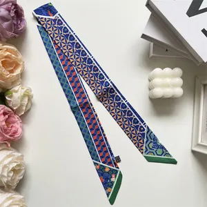 Detail of multi-pattern silk twilly scarf with floral prints and geometric shapes