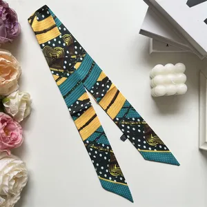 Primer plano de un pañuelo largo de seda con patrones geométricos y fondo decorativo