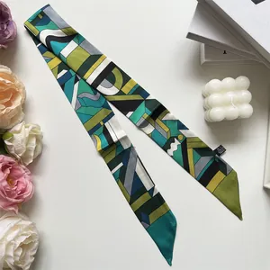 Abstract geometric color block silk scarf styled with modern decor on a white surface