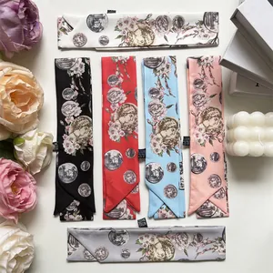Flat lay of elegant floral printed skinny scarves in multiple colors for hair and bags