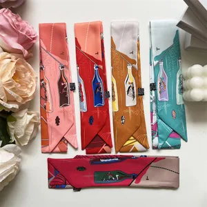 Flat lay of colorful nautical print silk scarves with decorative candles and flowers