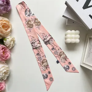 Pink silk twilly scarf with coin and flower print styled with candles and roses