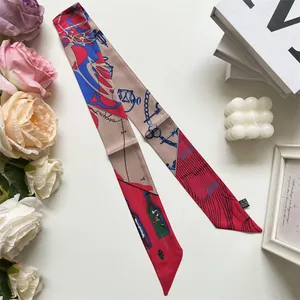 Close-up of elegant silk twilly scarf with nautical print and red blue khaki patterns
