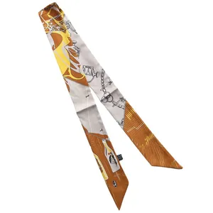 Narrow silk twilly scarf with yellow equestrian pattern displayed on white background