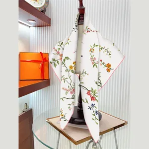 Premium twill square silk scarf 90x90cm with floral print shown on display stand