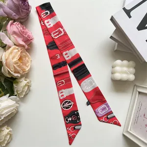 Detail of red French vintage double-sided silk twilly scarf with belt buckle patterns