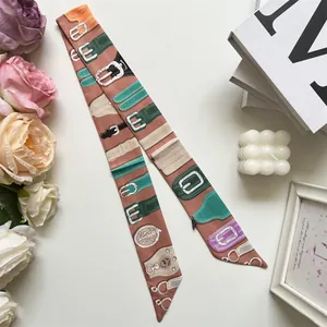Detail of elegant pink double-sided twilly silk scarf with vintage belt prints