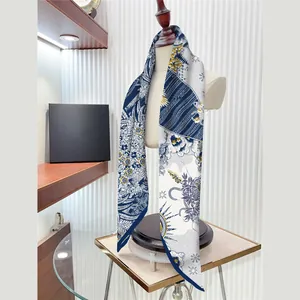 Elegant 90x90cm floral star navy silk scarf draped on mannequin in a luxury boutique