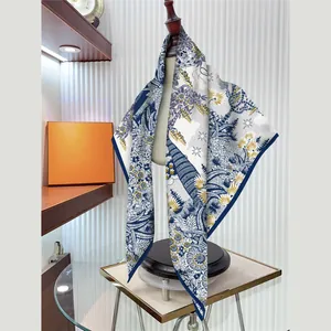 Silk-feel 90x90cm square scarf with blue and gold ethnic floral prints on mannequin