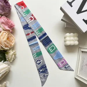 Detail of elegant two-sided silk twilly scarf with horse harness patterns and diagonal cut
