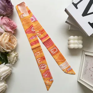 Close-up of double-sided silk twilly scarf with buckle print for handbag handle decoration