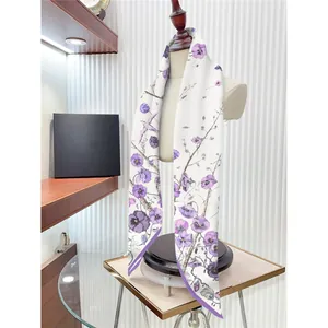 Floral silk scarf with violet flowers and birds draped on a white mannequin