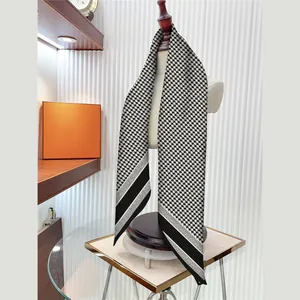 Elegant 90cm houndstooth silk scarf with black white stripes displayed on a mannequin